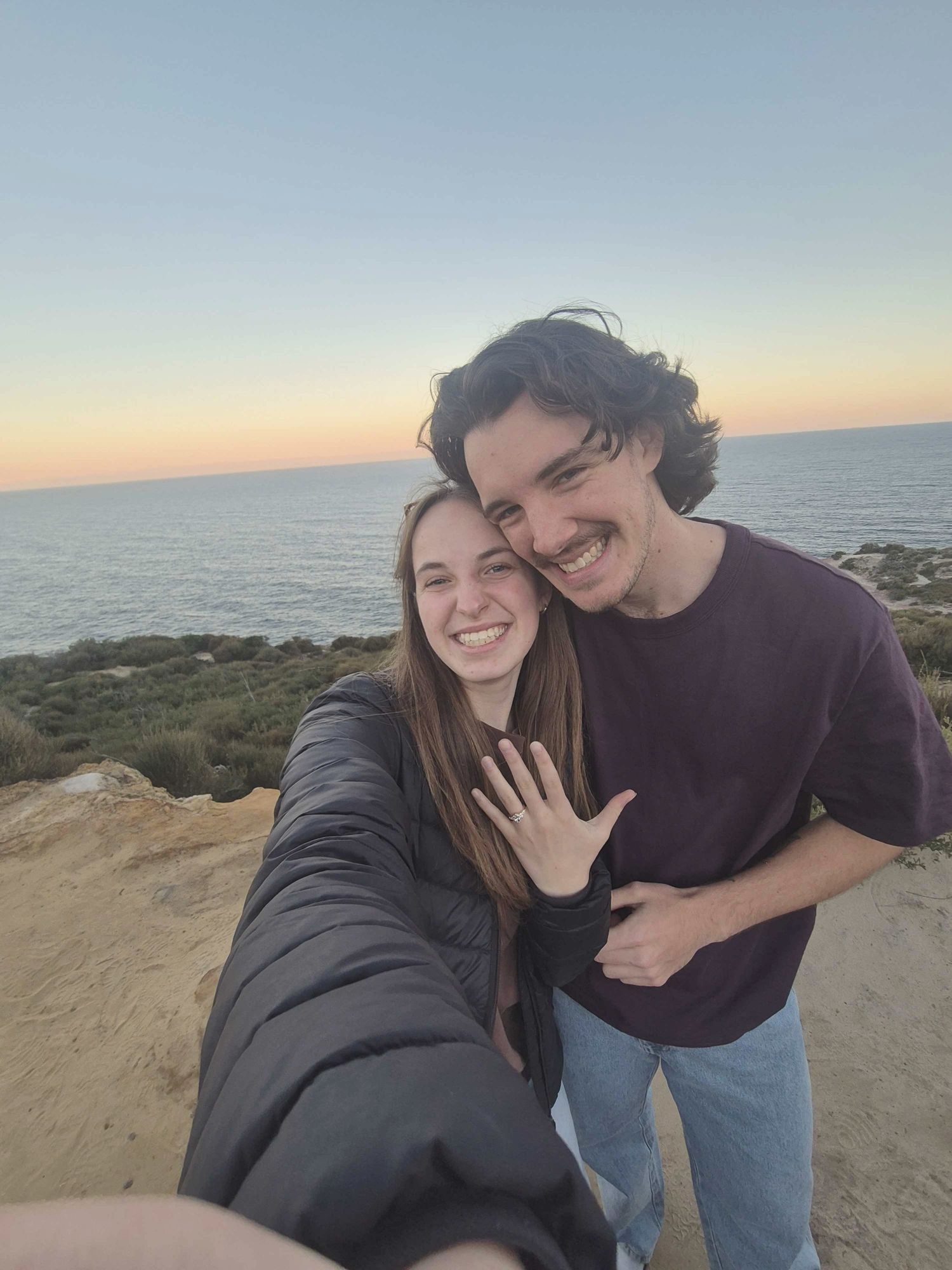 Jordan and Ruby on the headland at sunset, just engaged